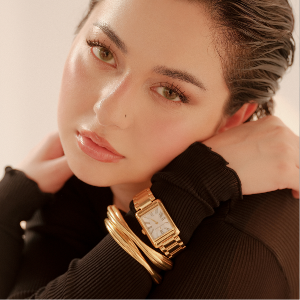 Hania Aamir wearing gold bangles and a watch